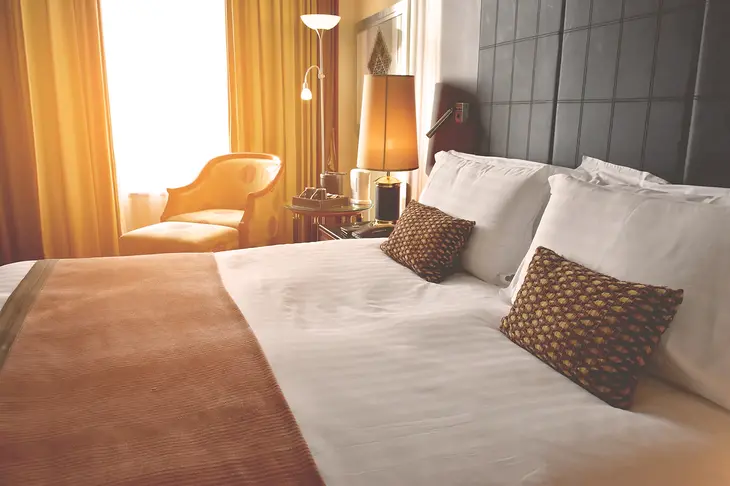 Cozy boutique hotel room with stylish decor and a comfortable bed, epitomizing personalized hospitality